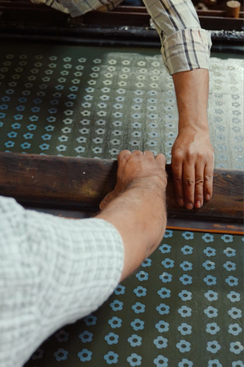 Jaipur artisan hand block printing indigo fabric — traditional craft behind Daughters of India